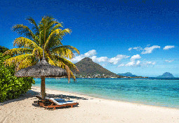 Loungers and umbrella on tropical beach on Mauritius Island